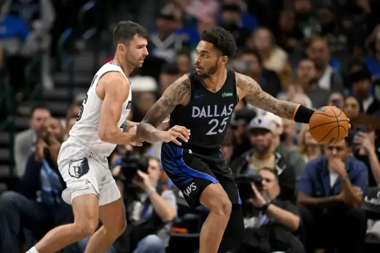 Nov 22, 2025; Dallas, Texas, USA; Dallas Mavericks center Dereck Lively II (2)5 looks to move the ball past Memphis Grizzlies guard John Konchar (46) during the game between the Mavericks and the Grizzlies at American Airlines Center. Mandatory Credit: Jerome Miron-Imagn Images